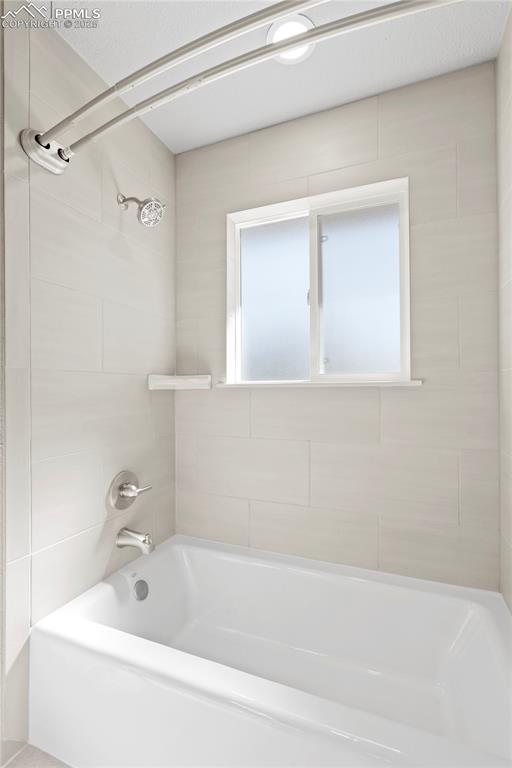 Image 7 of 35: Bathroom with washtub / shower combination