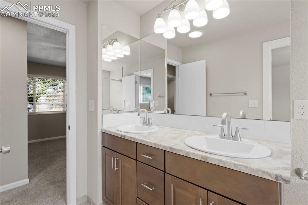Image 8 of 35: Full bath featuring double vanity, light colored carpet, and a shower