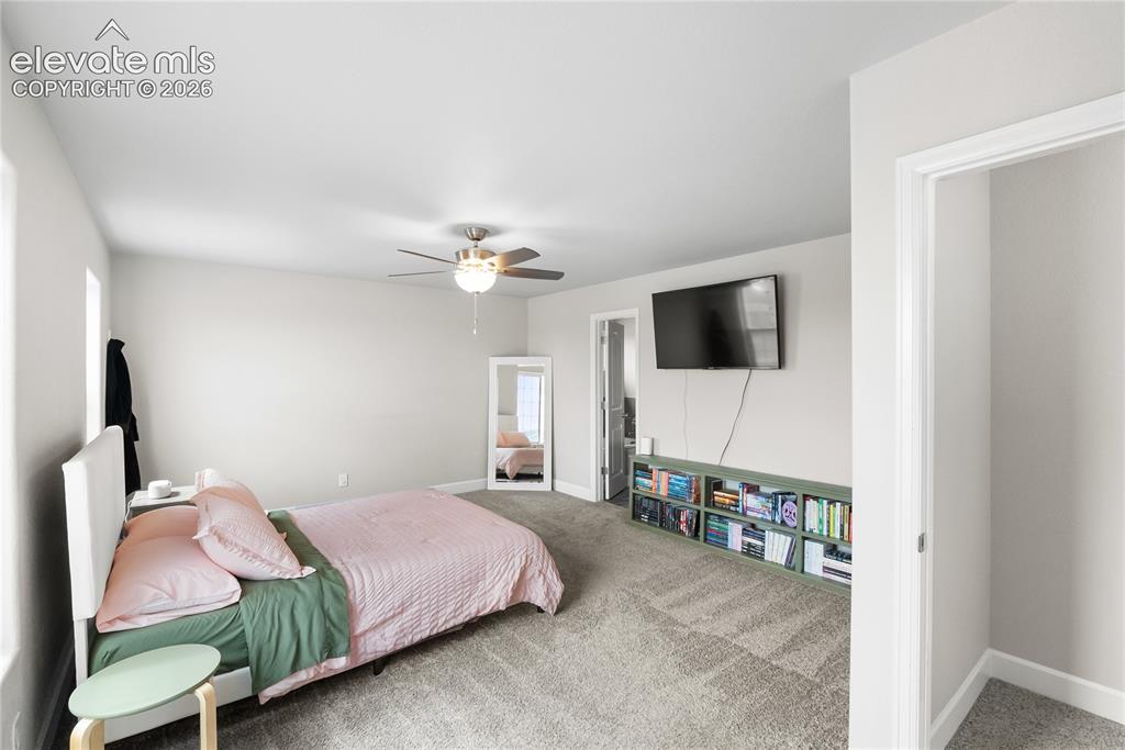Image 25 of 42: Spacious room featuring neutral paint, soft grey carpeting, a ceiling fan w
