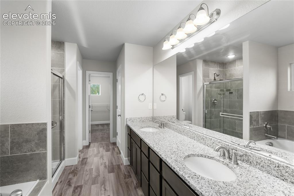 Image 27 of 42: Dual vanity with granite countertops and undermount sinks