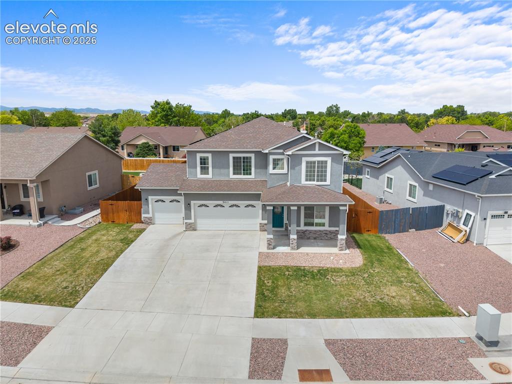 Image 35 of 42: Two-story residence featuring a gray exterior with white trim accents