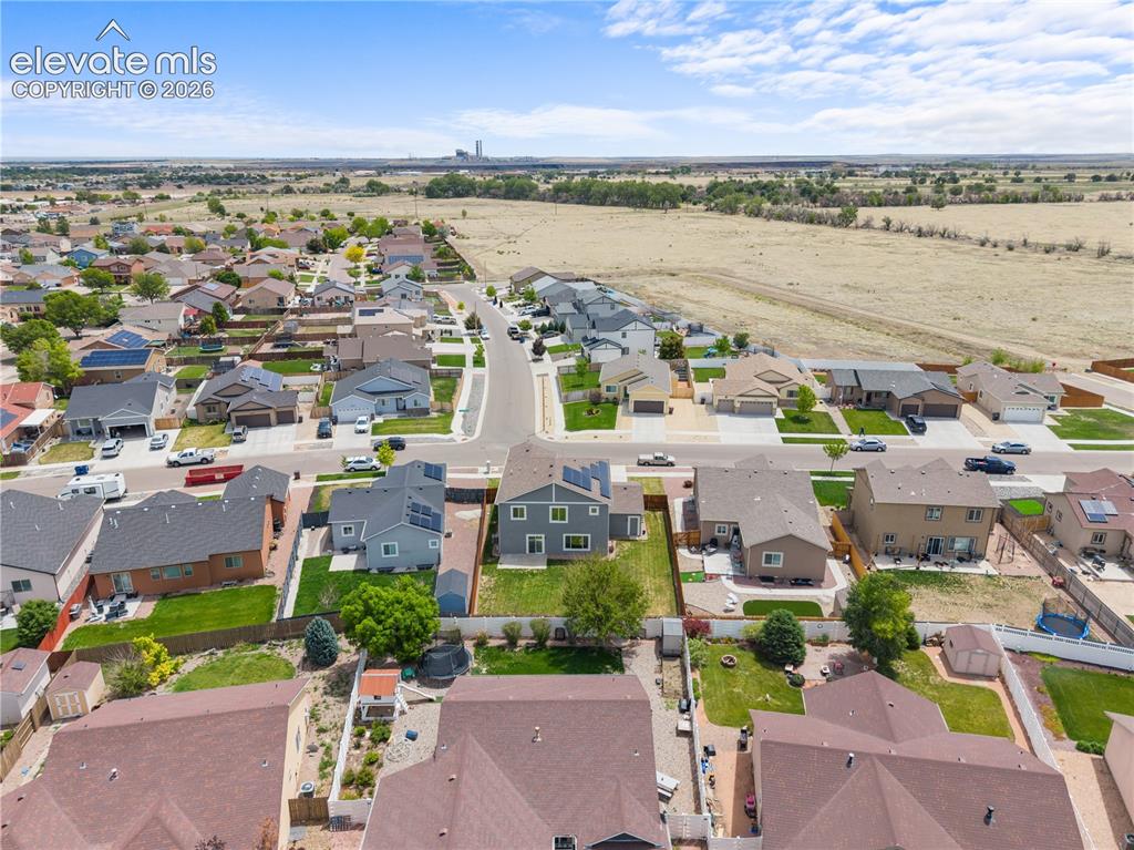 Image 40 of 42: Aerial perspective showcasing a residential street with detached homes, eac