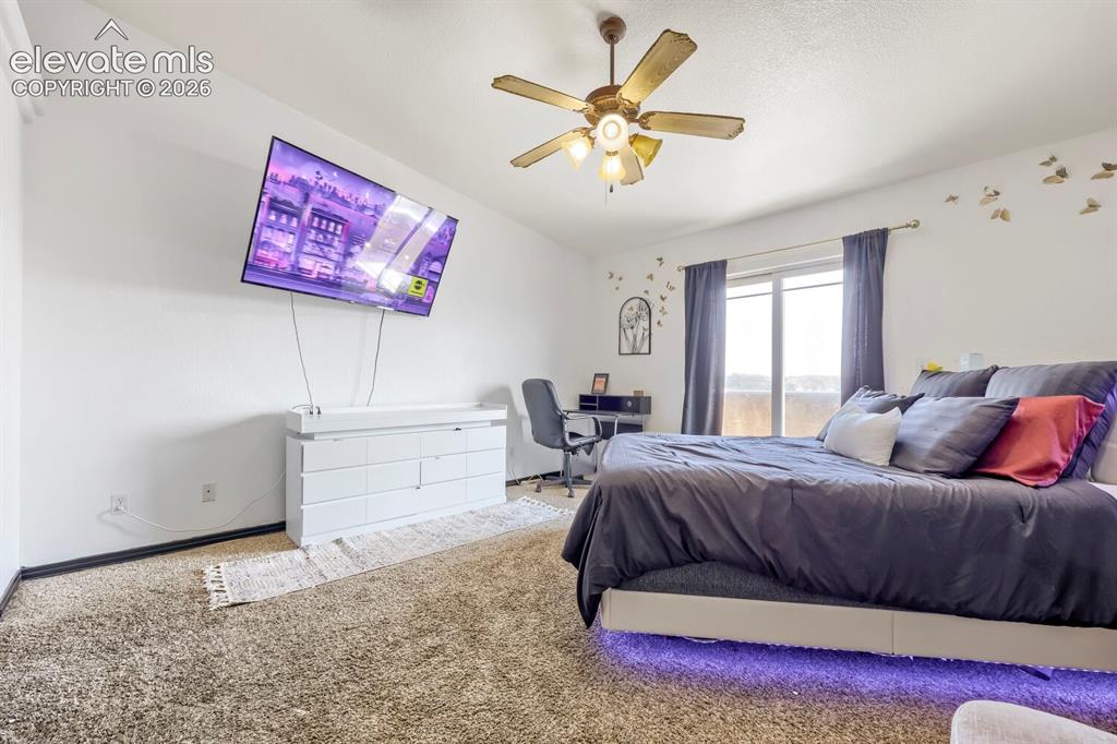 Image 7 of 17: Sloped ceiling with ceiling fan and overhead lighting