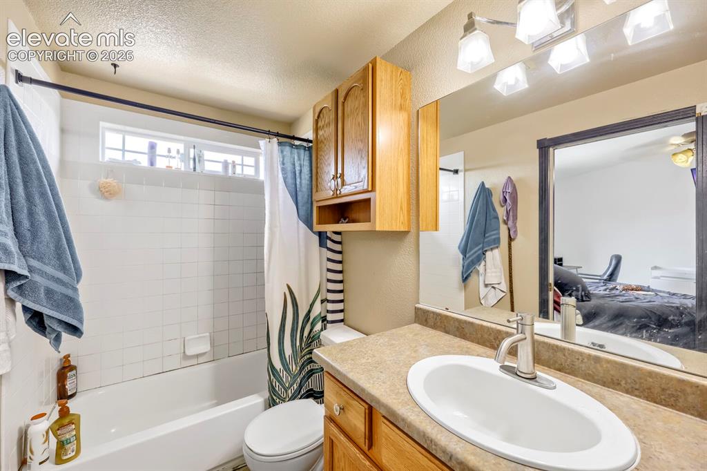 Image 9 of 17: White tile shower surround with integrated bathtub, transom window, and int