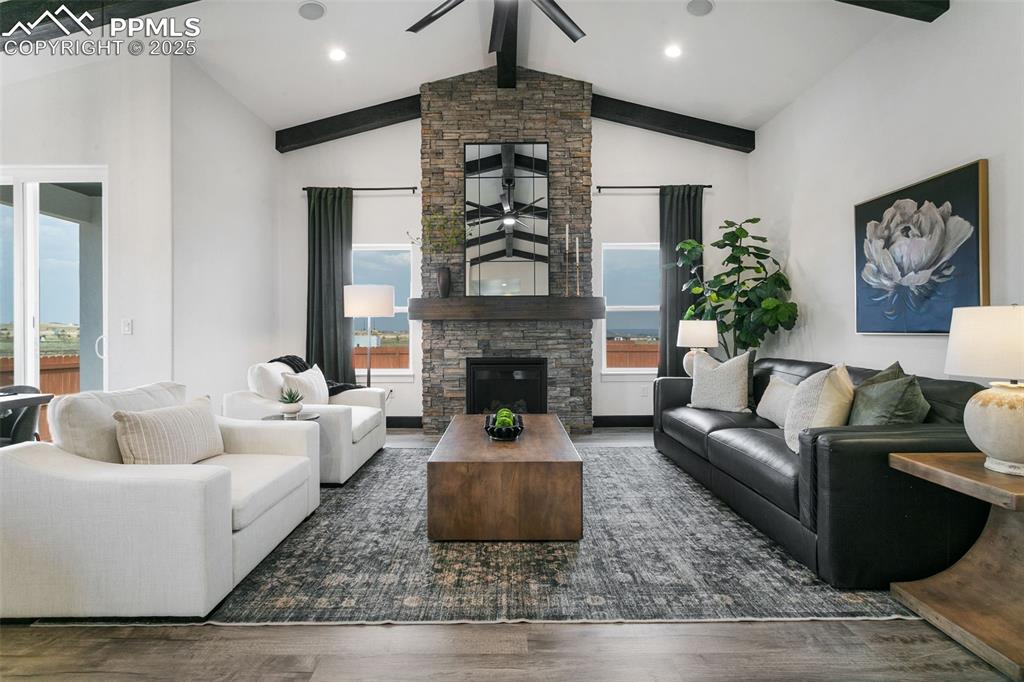 Image 10 of 23: Living room featuring ceiling fan, a fireplace, wood finished floors, reces