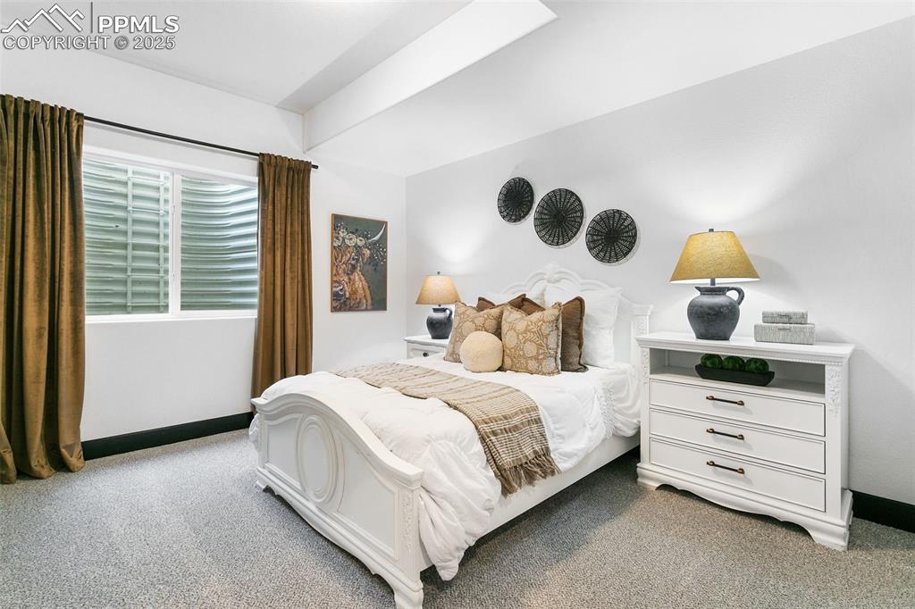 Image 21 of 23: Bedroom with light colored carpet and baseboards