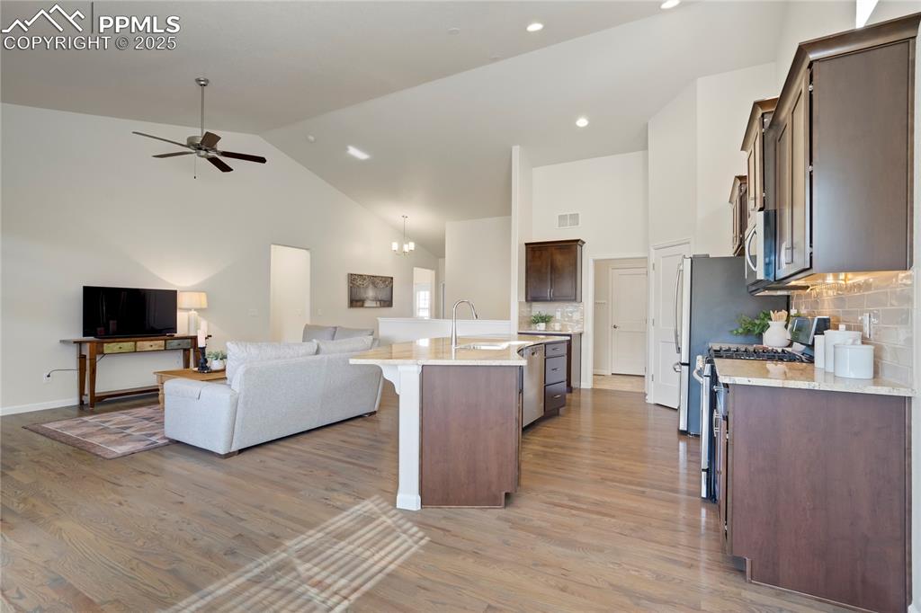 Image 10 of 50: Another view of the open kitchen and just beyond features a walk-in pantry