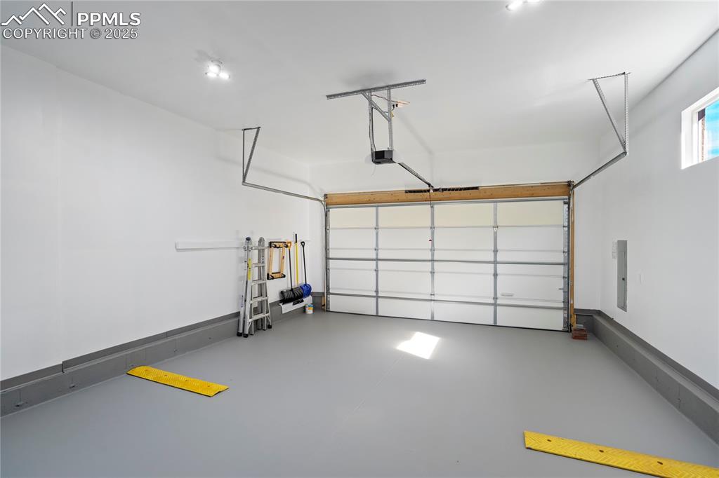 Image 41 of 50: Oversized Oversized finished garage w/epoxy floors—space for gear and more