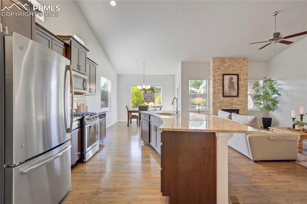 Image 9 of 50: Ample cabinetry w/under cabinet lighting, slab granite countertops, texture
