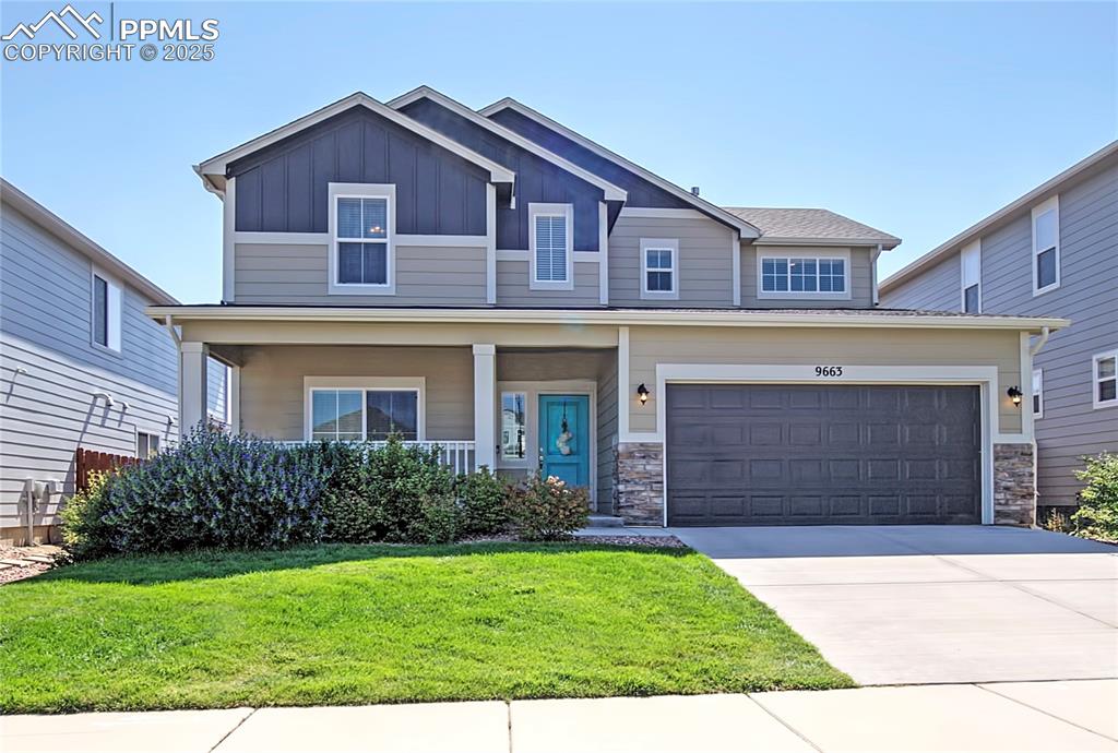 Caption: Craftsman inspired home with board and batten siding, a porch, a front lawn, concrete driveway, and 