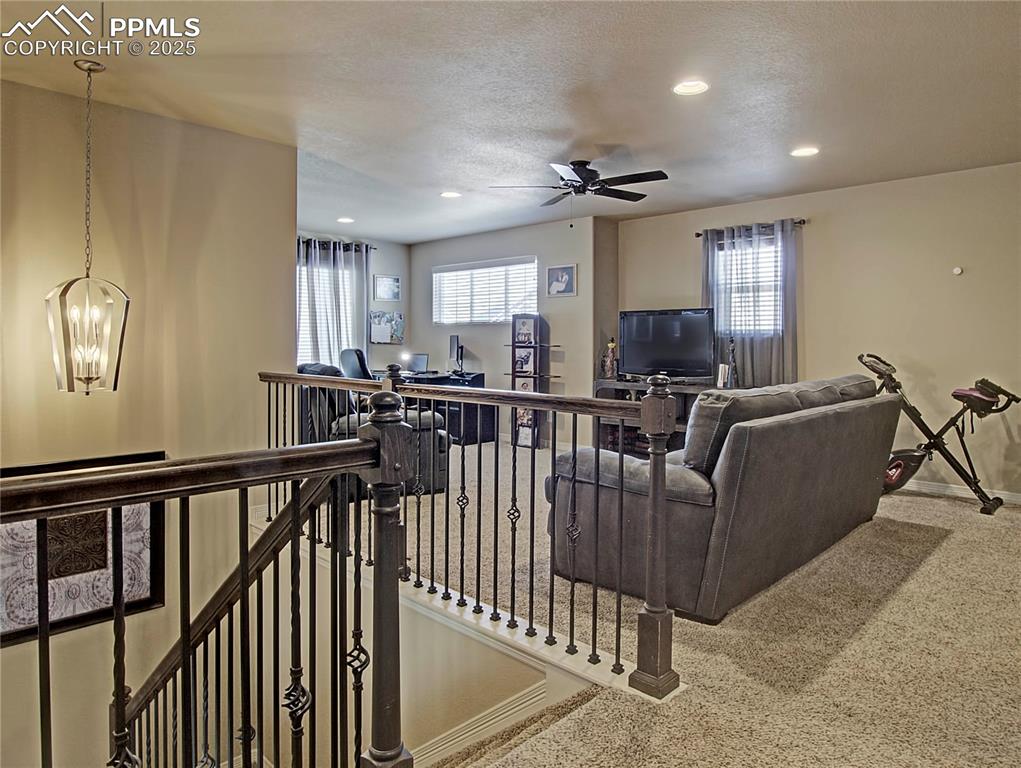 Image 16 of 30: Living area with plenty of natural light, recessed lighting, a textured cei