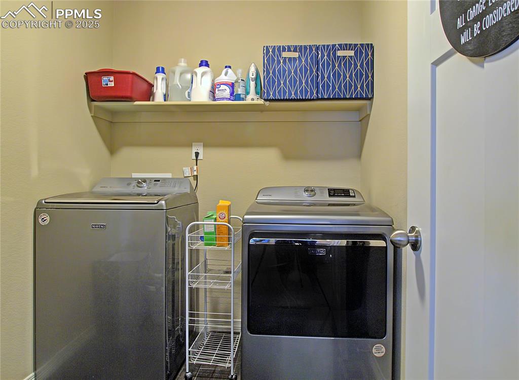 Image 21 of 30: Washroom featuring washing machine and clothes dryer