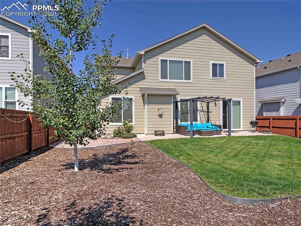 Image 29 of 30: Back of house with a fenced backyard, a patio area, and outdoor lounge area