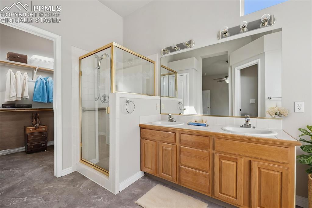 Image 9 of 29: Virtually Staged Master Bathroom with a shower stall, ceiling fan, a sink,