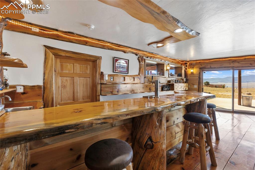 Image 29 of 48: Great entertaining area with live edge bar top
