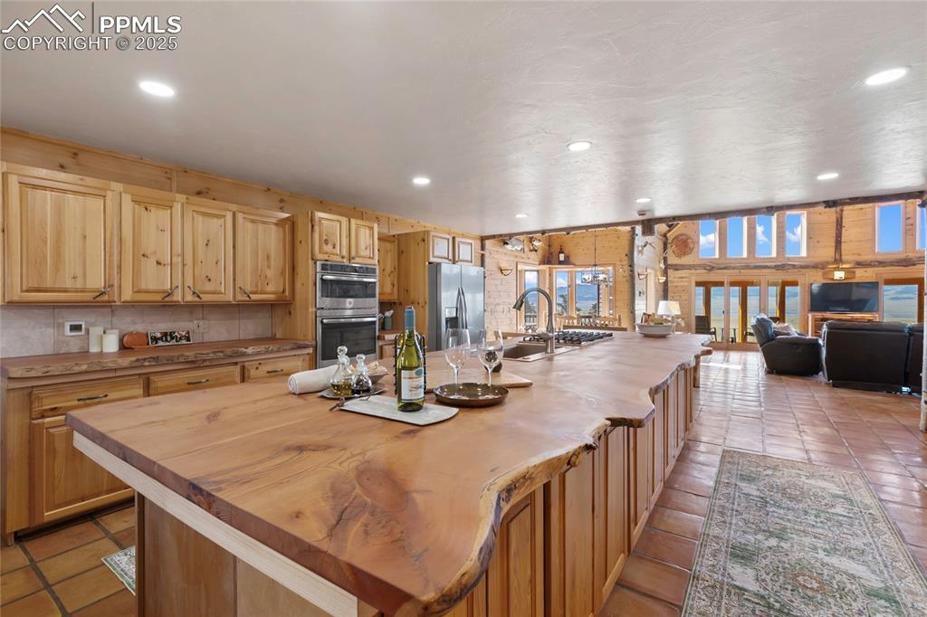 Image 3 of 48: Expansive live-edge kitchen island