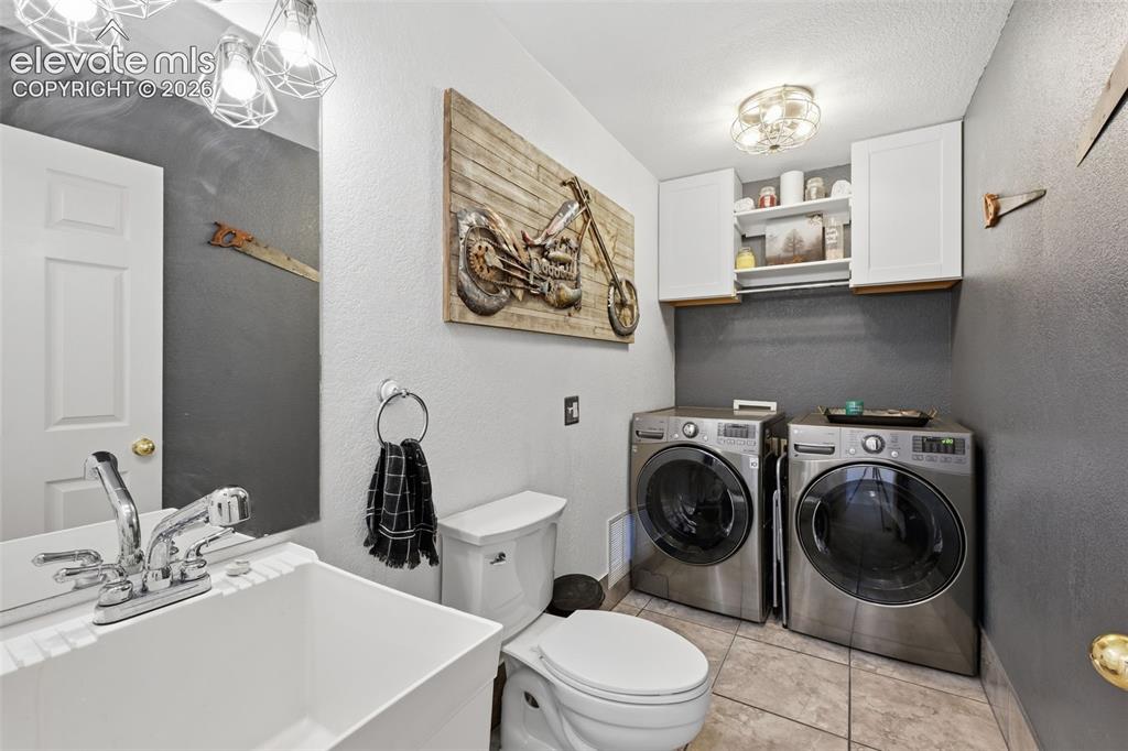 Image 18 of 43: Laundry with half bath