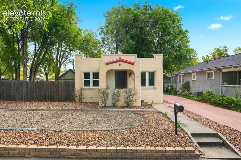 Image 1 of 40: Stucco exterior with a red tiled entry overhang