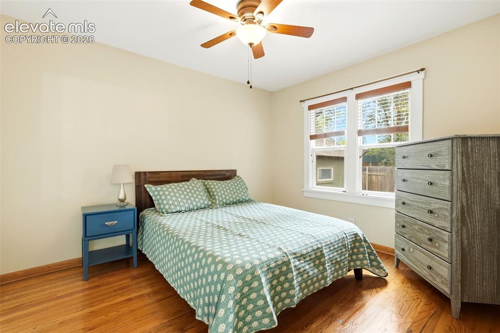 Image 12 of 40: Warm wood-finish flooring complements neutral walls