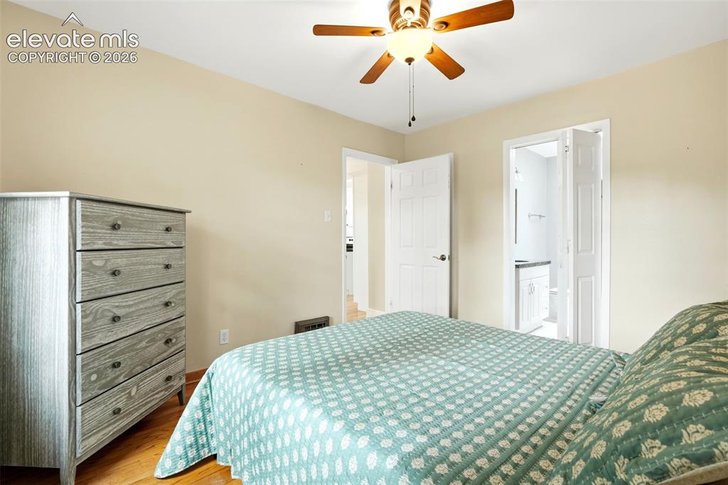 Image 13 of 40: Bedroom featuring wood-finish flooring, a ceiling fan with integrated light