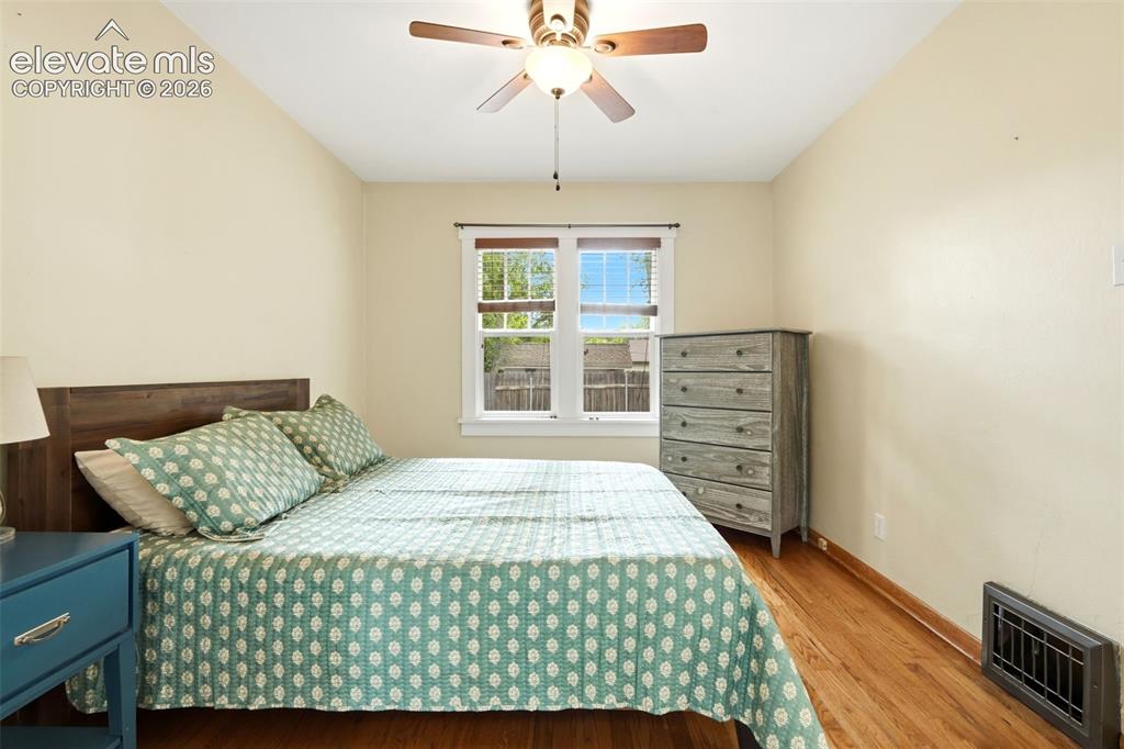 Image 14 of 40: Hardwood-style flooring throughout this room, featuring a window with white
