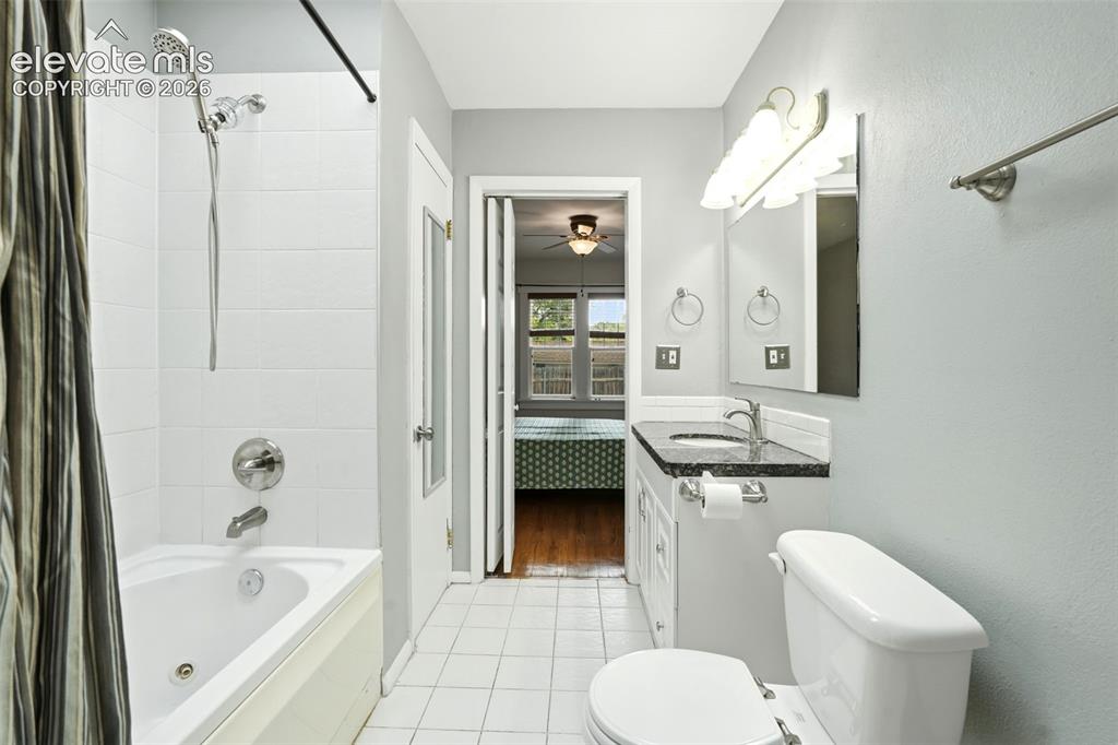 Image 16 of 40: Bathroom featuring a white tile floor, white tiled bath/shower combination