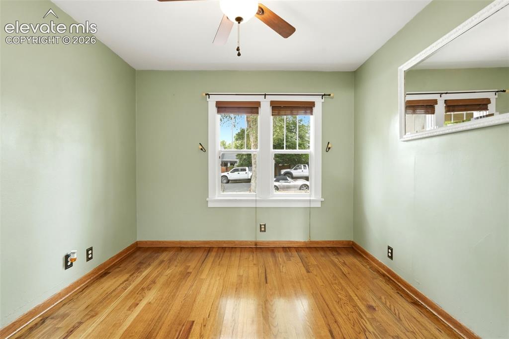 Image 17 of 40: Room featuring wood flooring and a ceiling fan with light fixture