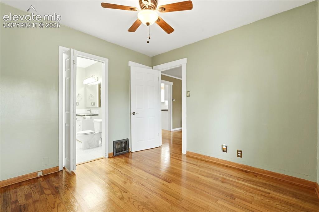 Image 18 of 40: Room featuring wood-finish flooring, light green painted walls, and a ceili