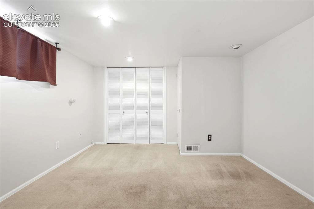 Image 22 of 40: Carpeted interior space featuring louvered bi-fold closet doors, recessed l