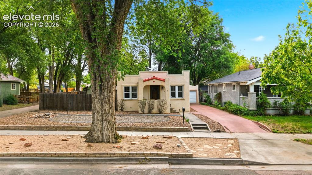 Image 3 of 40: Stucco exterior with a terracotta roof accent, single-car garage, and a lon