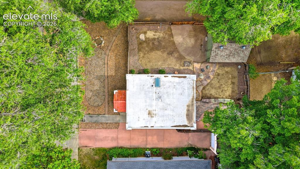 Image 33 of 40: Aerial overview showcasing a rectangular property with mature perimeter tre