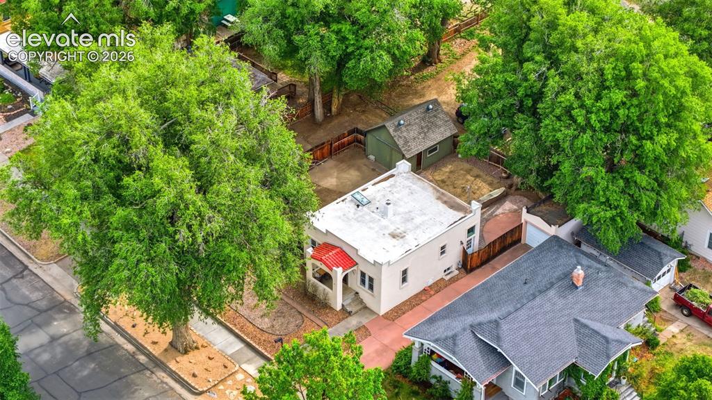 Image 34 of 40: Aerial perspective showcasing a property with a white stucco exterior and a