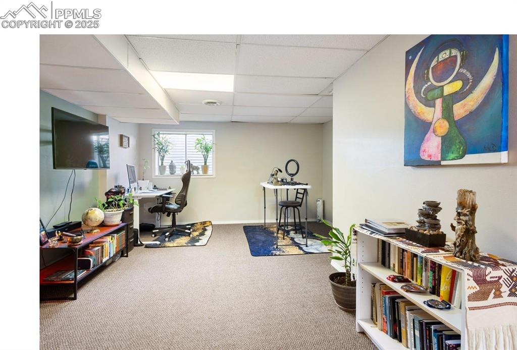 Image 16 of 27: Family room in basement with recently replaced carpet flooring. Could be 3r