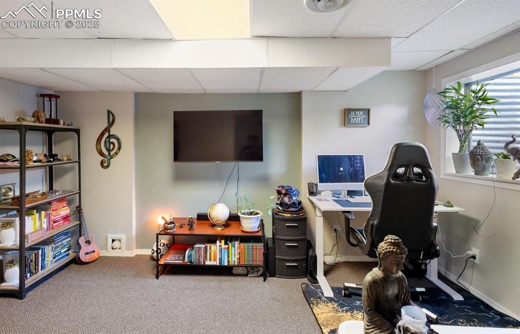 Image 17 of 27: Family room in basement with recently replaced carpet flooring. Could be 3r