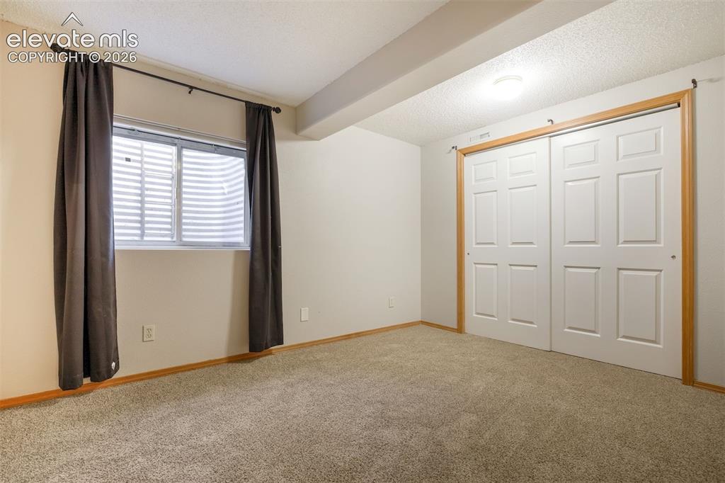 Image 42 of 50: Wall-to-wall carpeting and white walls