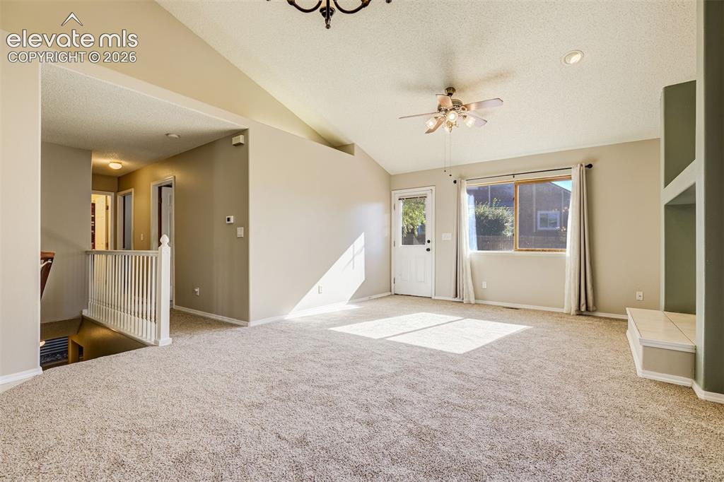 Image 9 of 50: Vaulted ceiling with a ceiling fan, recessed lighting, carpet flooring, bui
