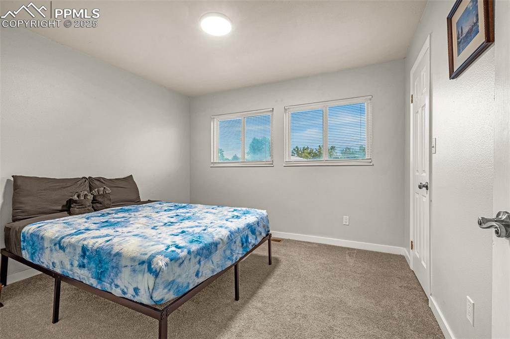 Image 12 of 22: Bedroom with carpet floors and baseboards