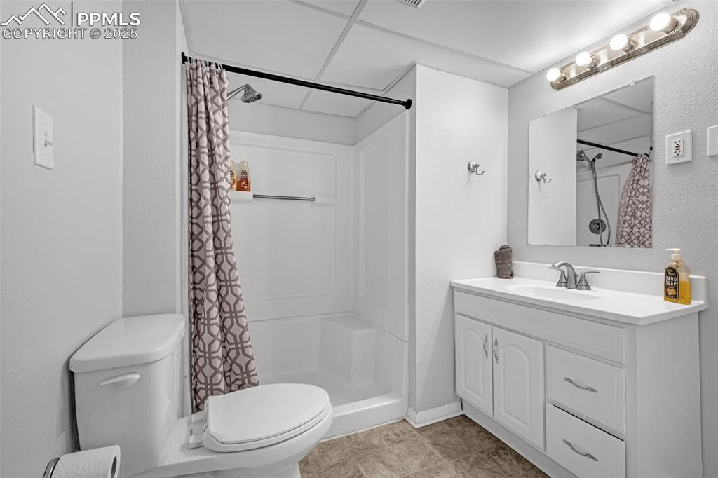 Image 19 of 22: Full bathroom with vanity, a stall shower, and light tile patterned floors