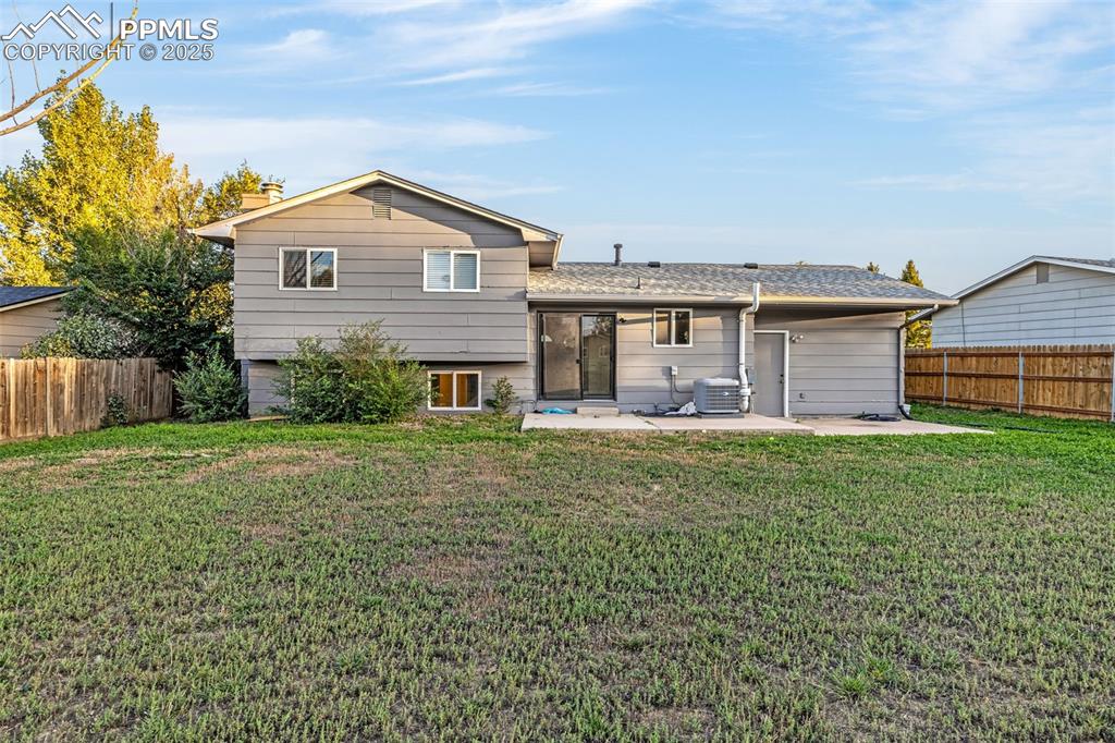 Image 20 of 22: Rear view of house with a fenced backyard, a patio area, a chimney, and a s
