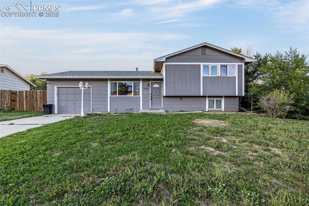 Image 3 of 22: Split level home featuring driveway and a garage