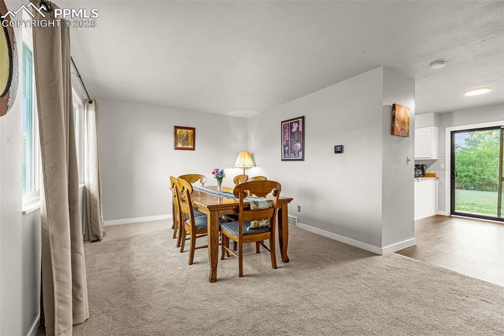 Image 5 of 22: Dining area with light colored carpet