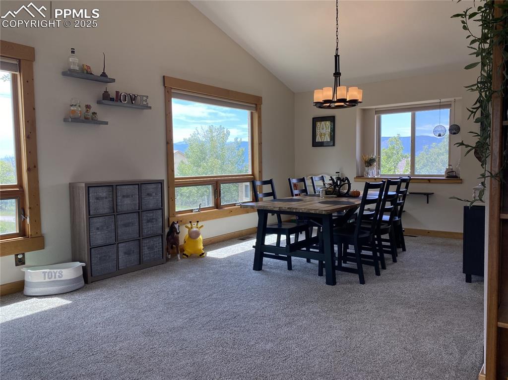 Image 21 of 48: The dining room is surrounded with mountain views