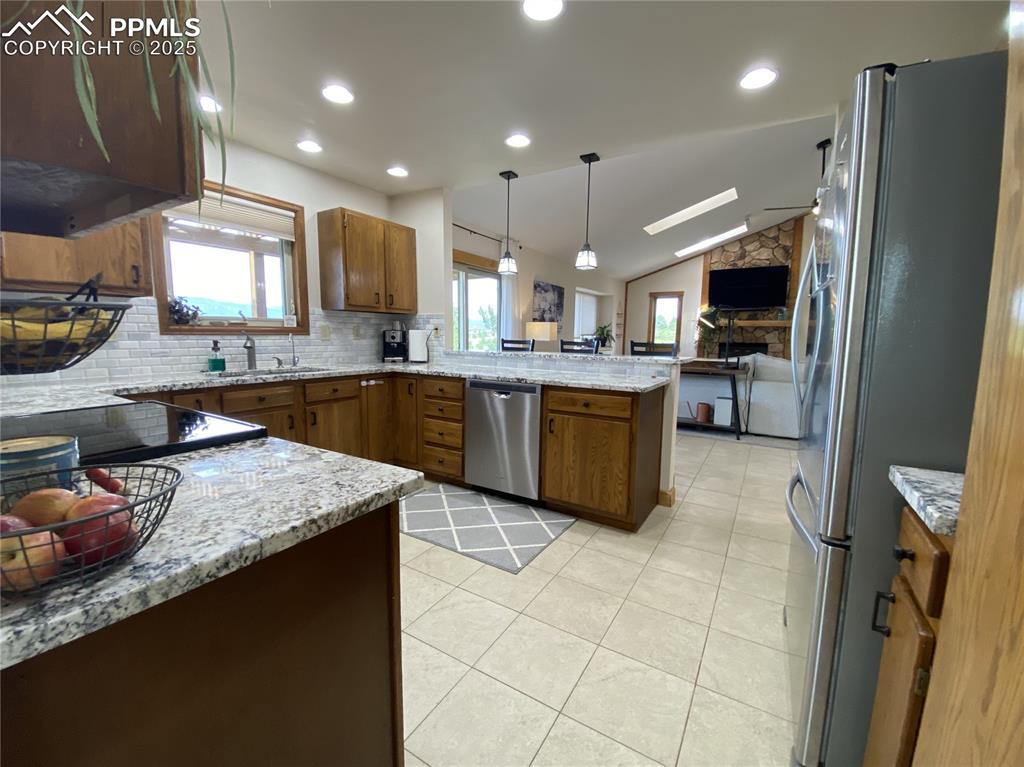 Image 23 of 48: Granite countertops & ceramic tile flooring