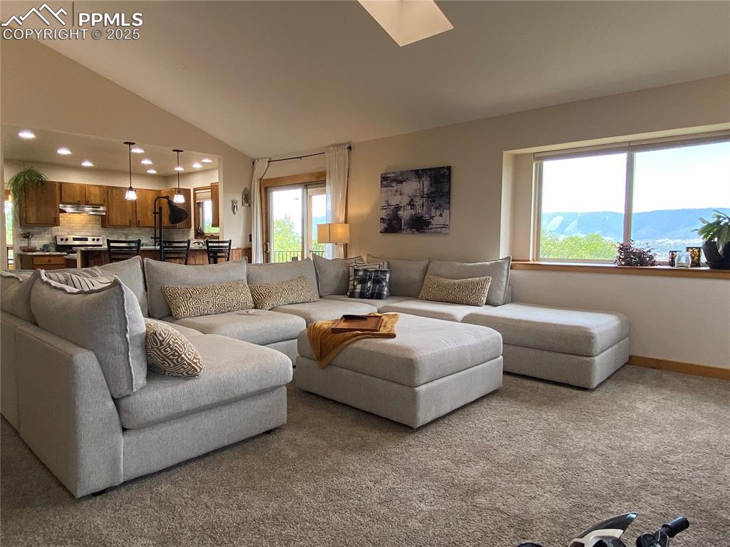 Image 28 of 48: Living room windows feature mountain views from inside