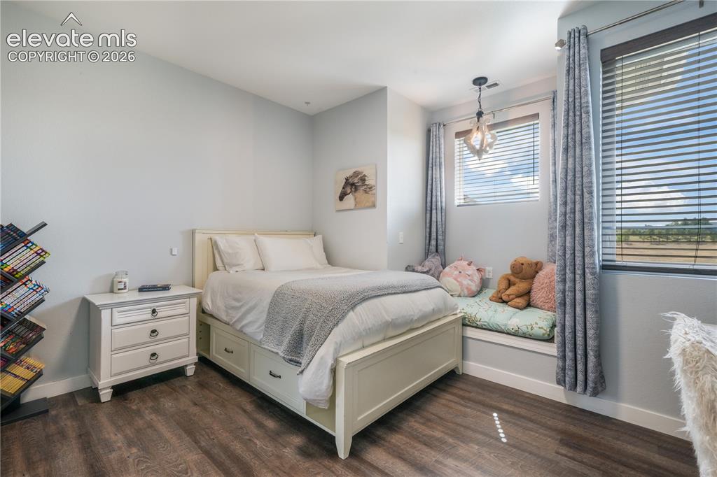 Image 37 of 50: Upper level bedroom with LVP flooring and spacious closet