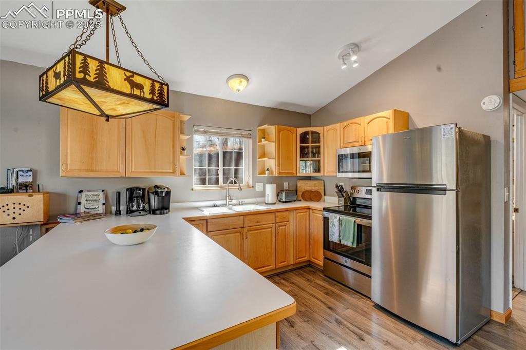 Image 14 of 34: Kitchen featuring light countertops, appliances with stainless steel finish