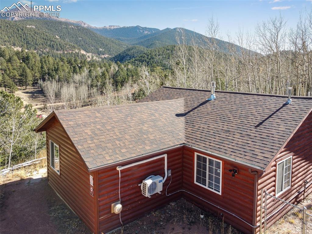 Image 29 of 34: View of mountain backdrop with a forest