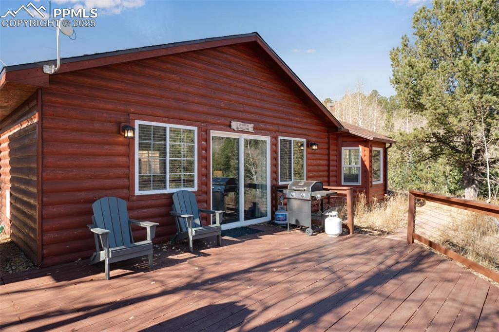 Image 5 of 34: Wooden deck featuring grilling area