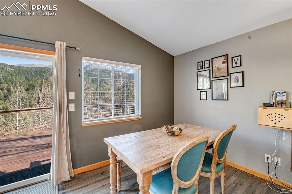 Image 9 of 34: Dining space featuring lofted ceiling and wood finished floors