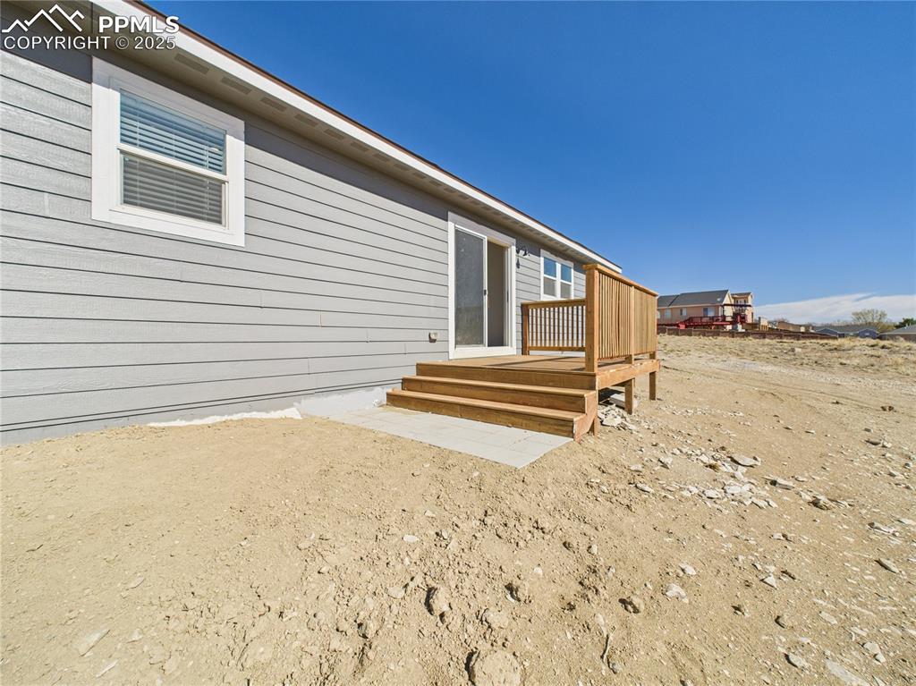 Image 42 of 50: Back yard featuring a wooden deck